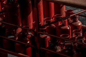A collection of red gas cylinders stored in an industrial setting, Dubai.